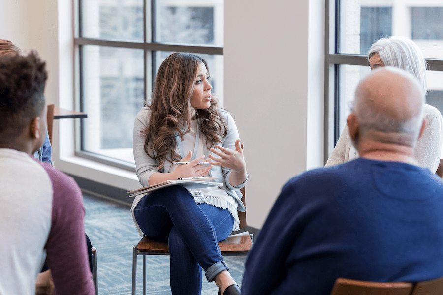 A leadership team discussing important matters at a table in a meeting room.